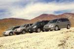 Group of 2005 minivans in desert