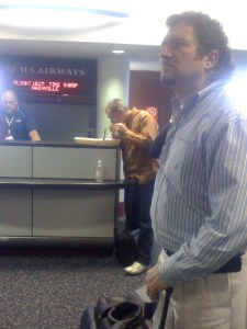 A man eating bbq at the airport